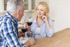 close-up-senior-couple-enjoying-wine-kitchen